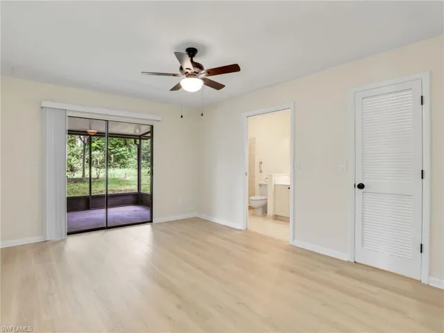Unfurnished bedroom with a closet, connected bathroom, ceiling fan, light wood-type flooring, and access to outside
