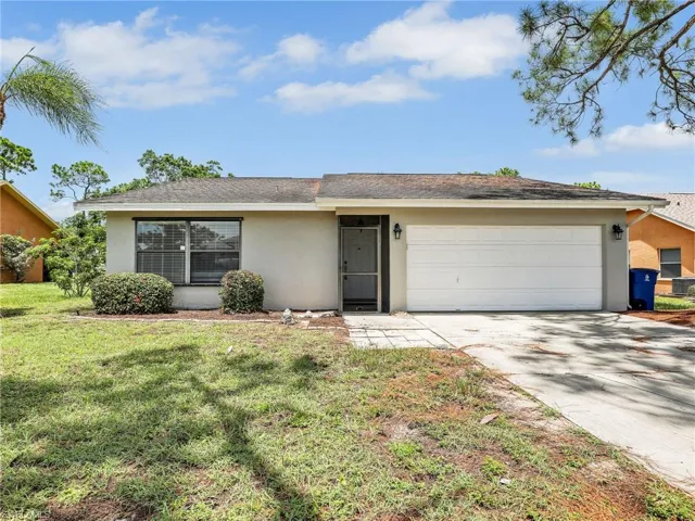 Ranch-style home with a garage and a front yard