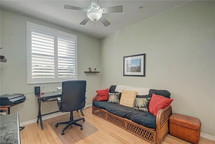 Office space with light wood-style flooring and a ceiling fan