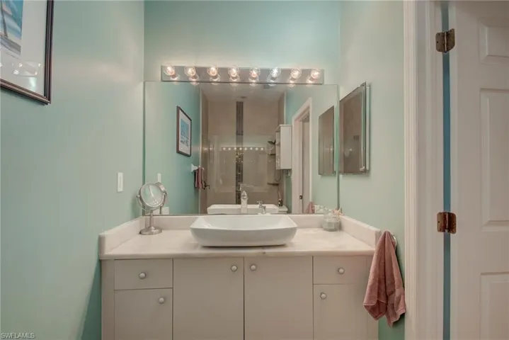 Bathroom featuring vanity and a stall shower