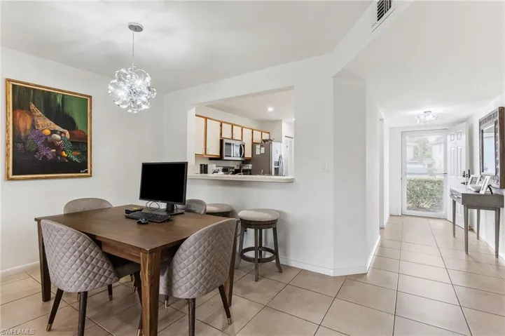 Dining area with baseboards, visible vents, a chandelier, and light tile patterned floors