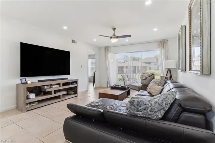 Living area featuring recessed lighting, baseboards, ceiling fan, and light tile patterned floors