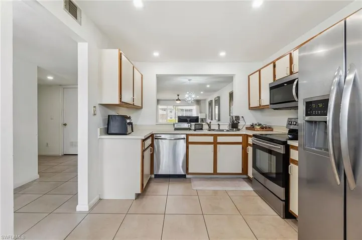 Kitchen featuring visible vents, recessed lighting, appliances with stainless steel finishes, light countertops, and light tile patterned floors