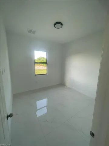 Unfurnished room with light tile patterned floors