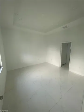 Empty room featuring light tile patterned flooring