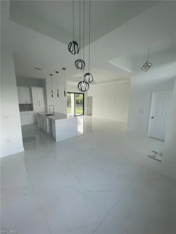 Unfurnished dining area featuring light tile patterned flooring and sink