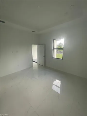 Empty room featuring light tile patterned flooring