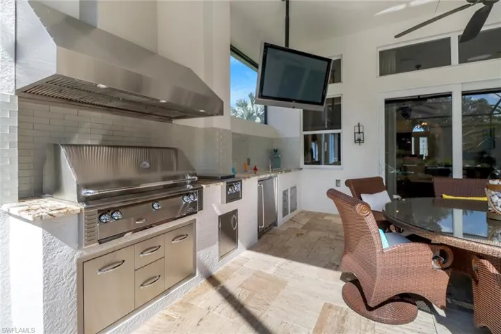 View of patio / terrace with area for grilling, a grill, and ceiling fan