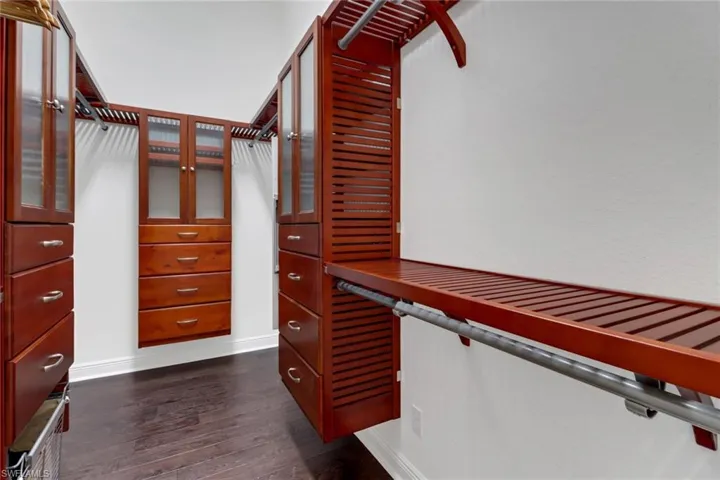 Walk in closet featuring dark hardwood / wood-style flooring