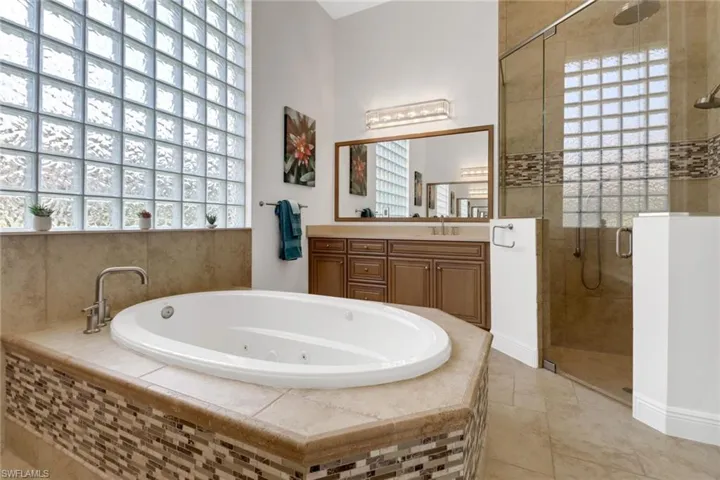 Bathroom featuring vanity and plus walk in shower