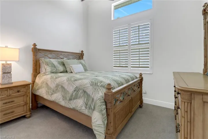 Bedroom featuring light carpet