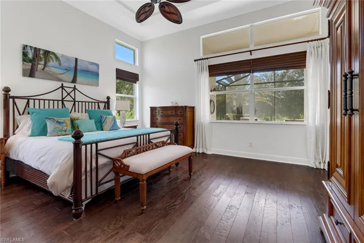Bedroom with ornamental molding, dark hardwood / wood-style floors, and ceiling fan