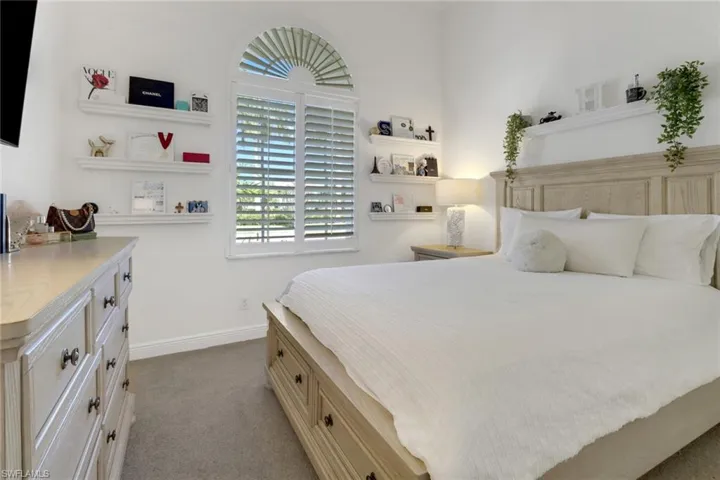 Bedroom featuring light carpet