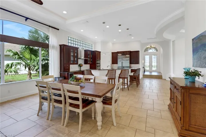 Dining room with french doors, ornamental molding, and a wealth of natural light