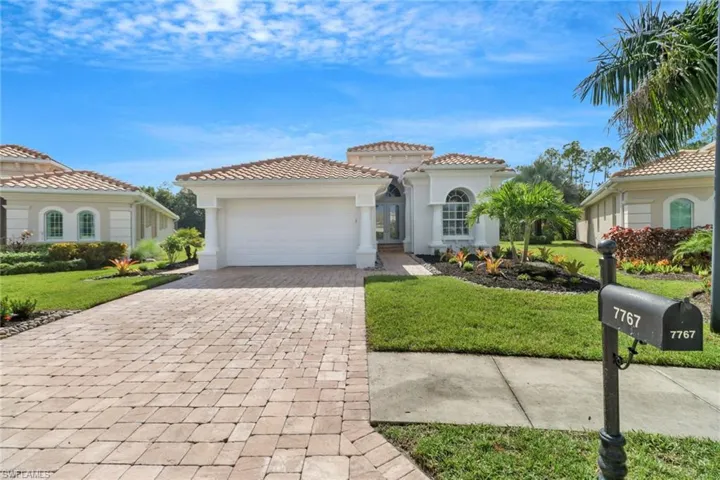 Mediterranean / spanish house featuring a front yard and a garage