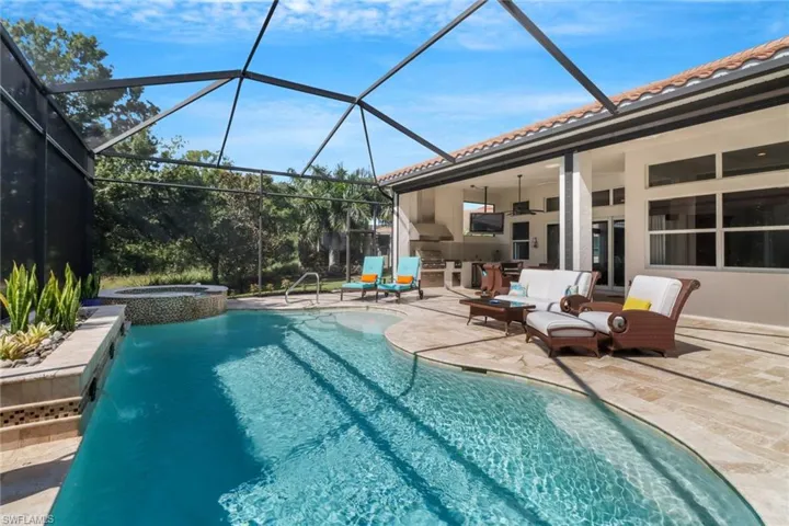 View of pool featuring an in ground hot tub, a patio, glass enclosure, and ceiling fan