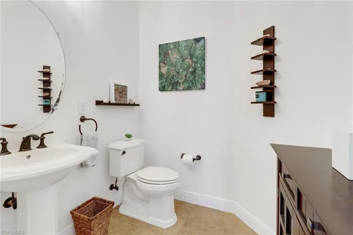 Bathroom featuring tile patterned floors, sink, and toilet