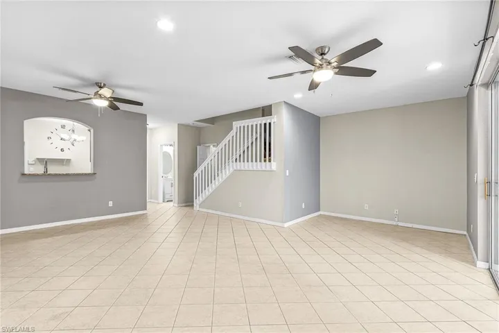Unfurnished room with ceiling fan, stairway, recessed lighting, and light tile patterned flooring