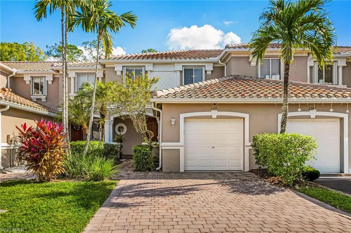 Mediterranean / spanish home featuring stucco siding, decorative driveway, a tile roof, and an attached garage