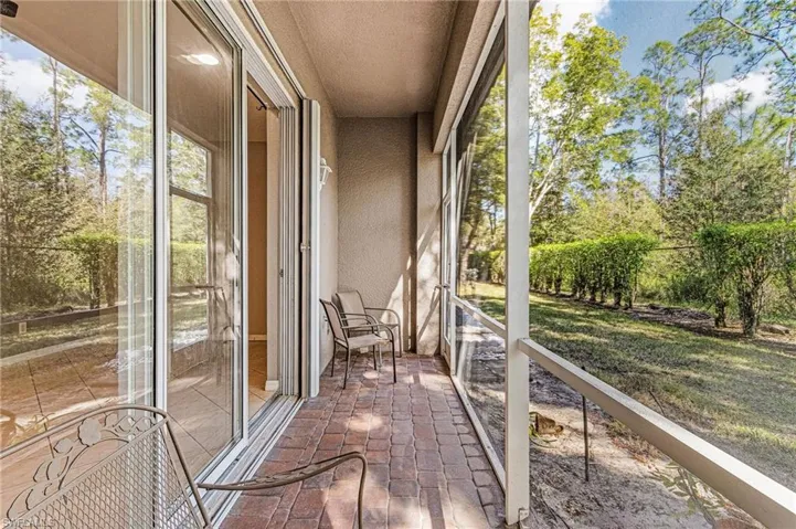 Unfurnished sunroom with brick flooring