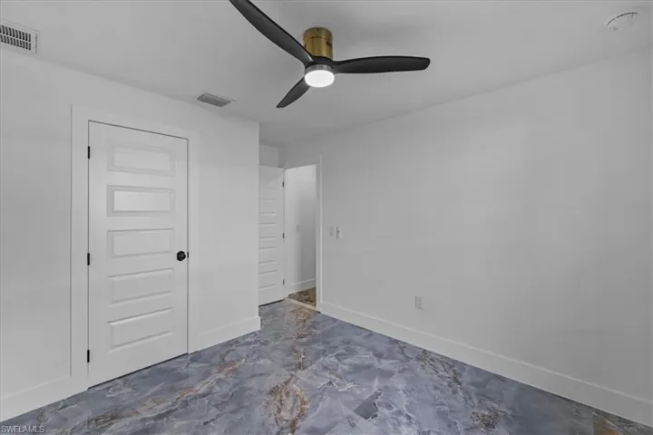 Unfurnished bedroom featuring a closet and a ceiling fan