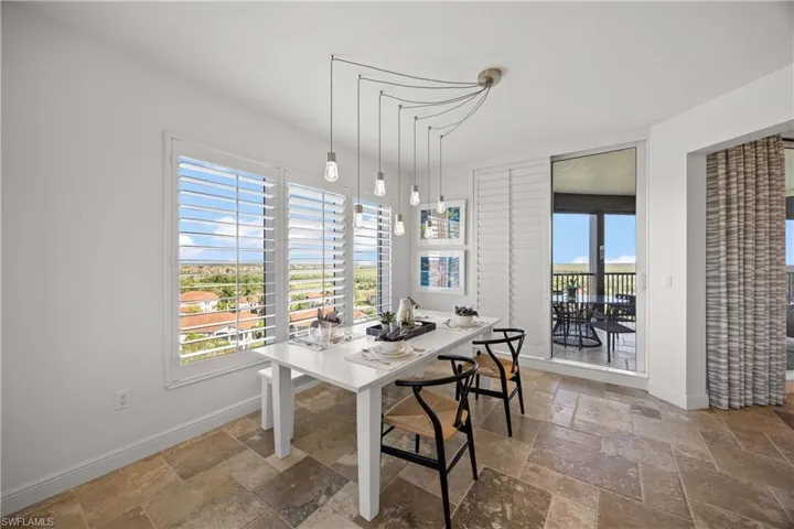 Dining area featuring baseboards and stone tile floors