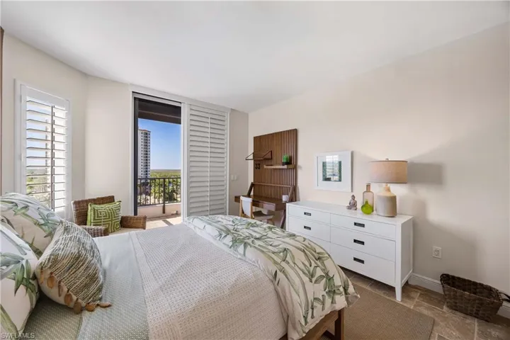 Bedroom with access to exterior and baseboards