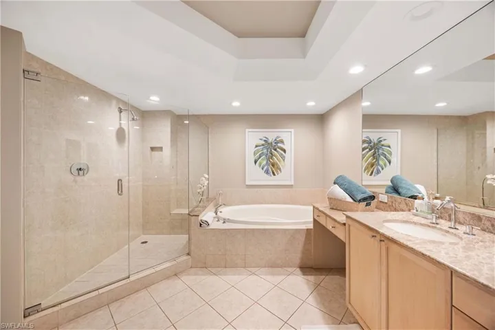 Full bath with light tile patterned flooring, vanity, a shower stall, a bath, and recessed lighting