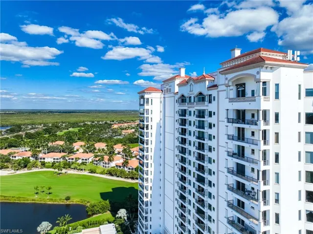 View of apartment building / complex with view of golf course and a water view