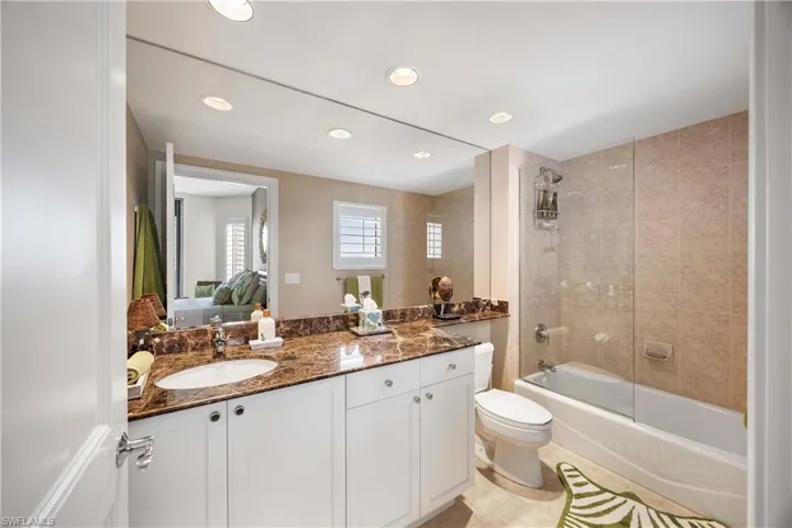 Bathroom featuring bathing tub / shower combination, vanity, recessed lighting, connected bathroom, and light tile patterned floors