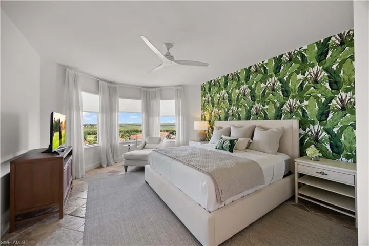 Bedroom featuring stone tile floors and a ceiling fan