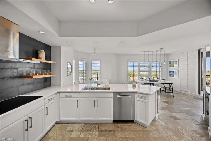 Kitchen featuring recessed lighting, open shelves, white cabinetry, stainless steel dishwasher, and backsplash