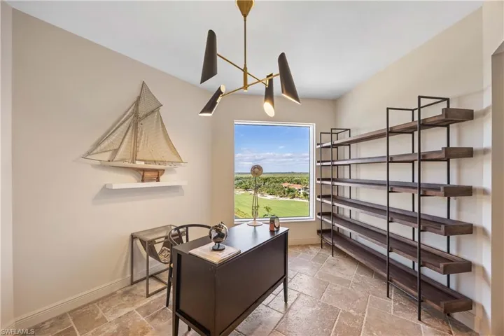 Office with stone tile floors and a chandelier
