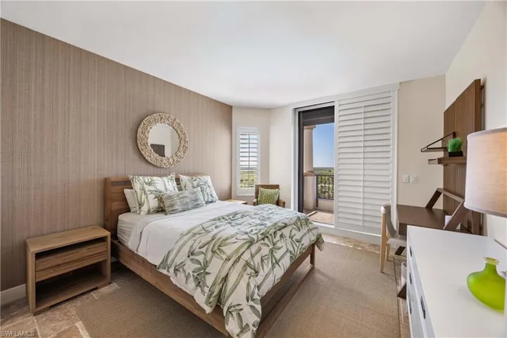 Bedroom featuring access to outside and baseboards