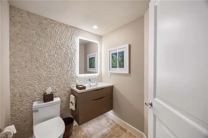 Half bath featuring vanity and baseboards