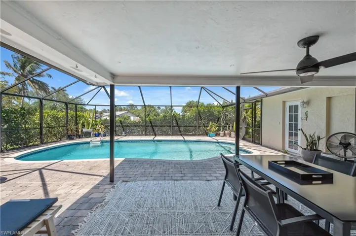 Outdoor pool featuring child safety enclosure and an patio area