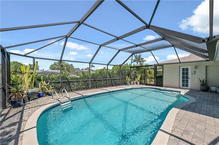Pool with a patio and a lanai with paver deck