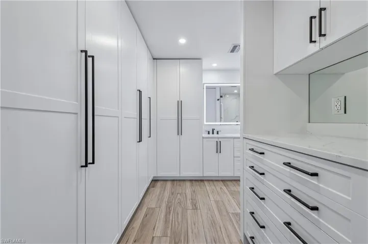 Walk in closet featuring visible vents and light wood-style tile flooring