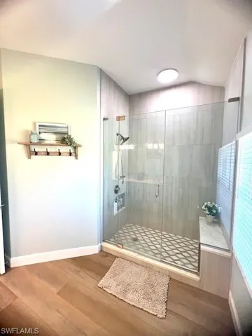 New Shower tiles, bench plumbing fixtures, and glass door.