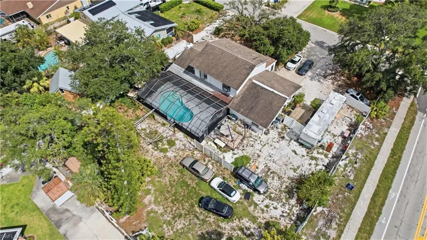 Two-story residential structure featuring a screened-in swimming pool