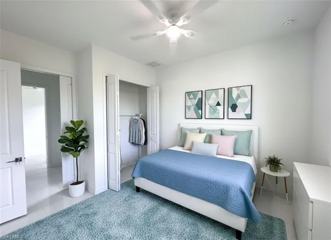 Bedroom with carpet, a closet, and a ceiling fan