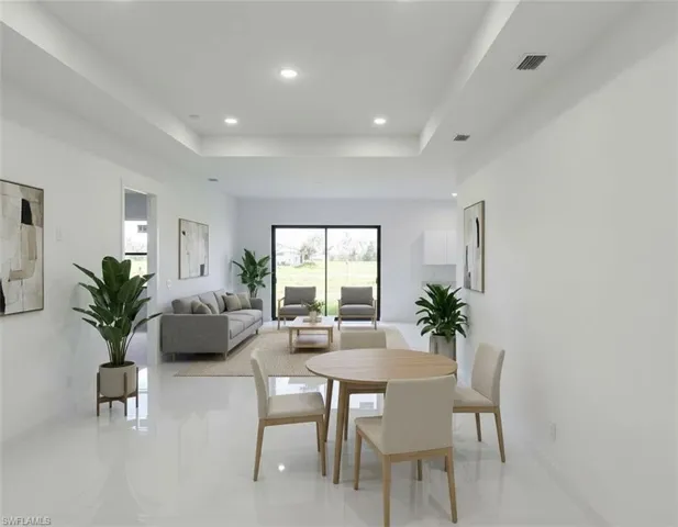 Dining room with a tray ceiling and recessed lighting