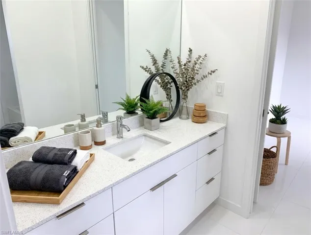 Bathroom featuring vanity and light tile patterned floors