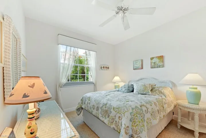 Carpeted bedroom with ceiling fan