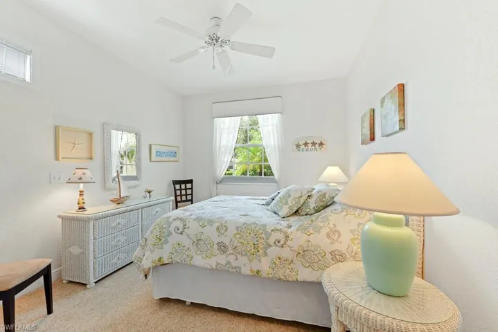 Carpeted bedroom featuring ceiling fan