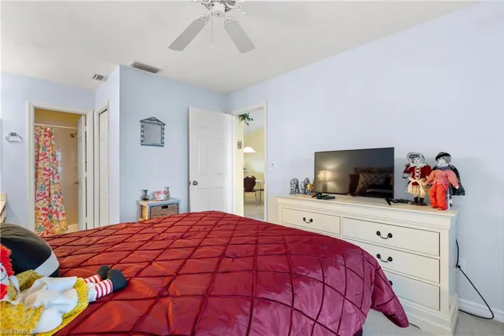 Carpeted bedroom with ceiling fan