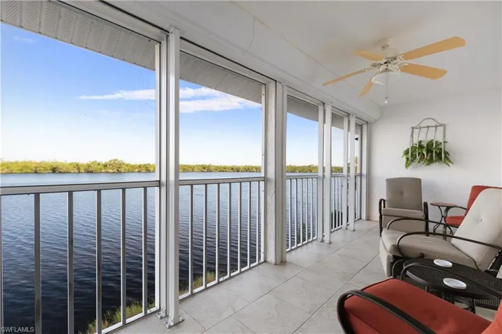 Sunroom with a water view and ceiling fan