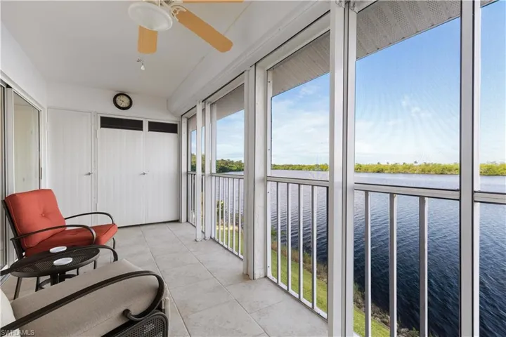 Sunroom with a water view and ceiling fan