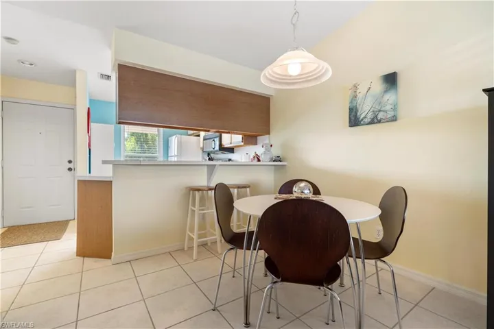 Dining room with light tile patterned flooring