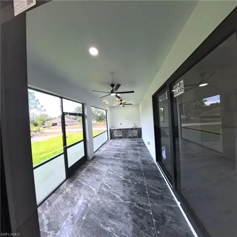 Unfurnished sunroom with a ceiling fan